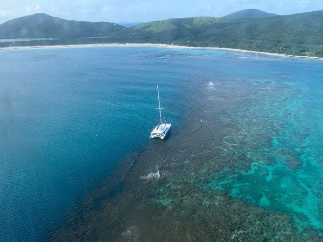 Photo showing the sailing vessel Obsession hard aground on a reef just off Flamenco Beach in Culebra, Puerto Rico, Aug. 15, 2024.  The Coast Guard continues to coordinate vessel removal operations with experts from Resolve Marine and local and federal partner environmental agencies. The sailing vessel originally ran aground July 21, 2024. (Coast Guard photo)