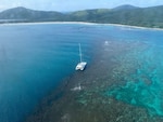 Photo showing the sailing vessel Obsession hard aground on a reef just off Flamenco Beach in Culebra, Puerto Rico, Aug. 15, 2024.  The Coast Guard continues to coordinate vessel removal operations with experts from Resolve Marine and local and federal partner environmental agencies. The sailing vessel originally ran aground July 21, 2024. (Coast Guard photo)