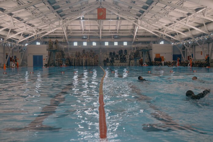 U.S. Marine Corps recruits with Bravo Company, 1st Recruit Training Battalion, participate in a swim qualification event at Marine Corps Recruit Depot San Diego, California, Aug. 13, 2024. The basic swim qualification consists of a 25-meter swim, tower jump into the water, four-minute tread, 25-meter pack swim, and an underwater gear shed. (U.S. Marine Corps photo by Cpl. Elliott A. Flood-Johnson)