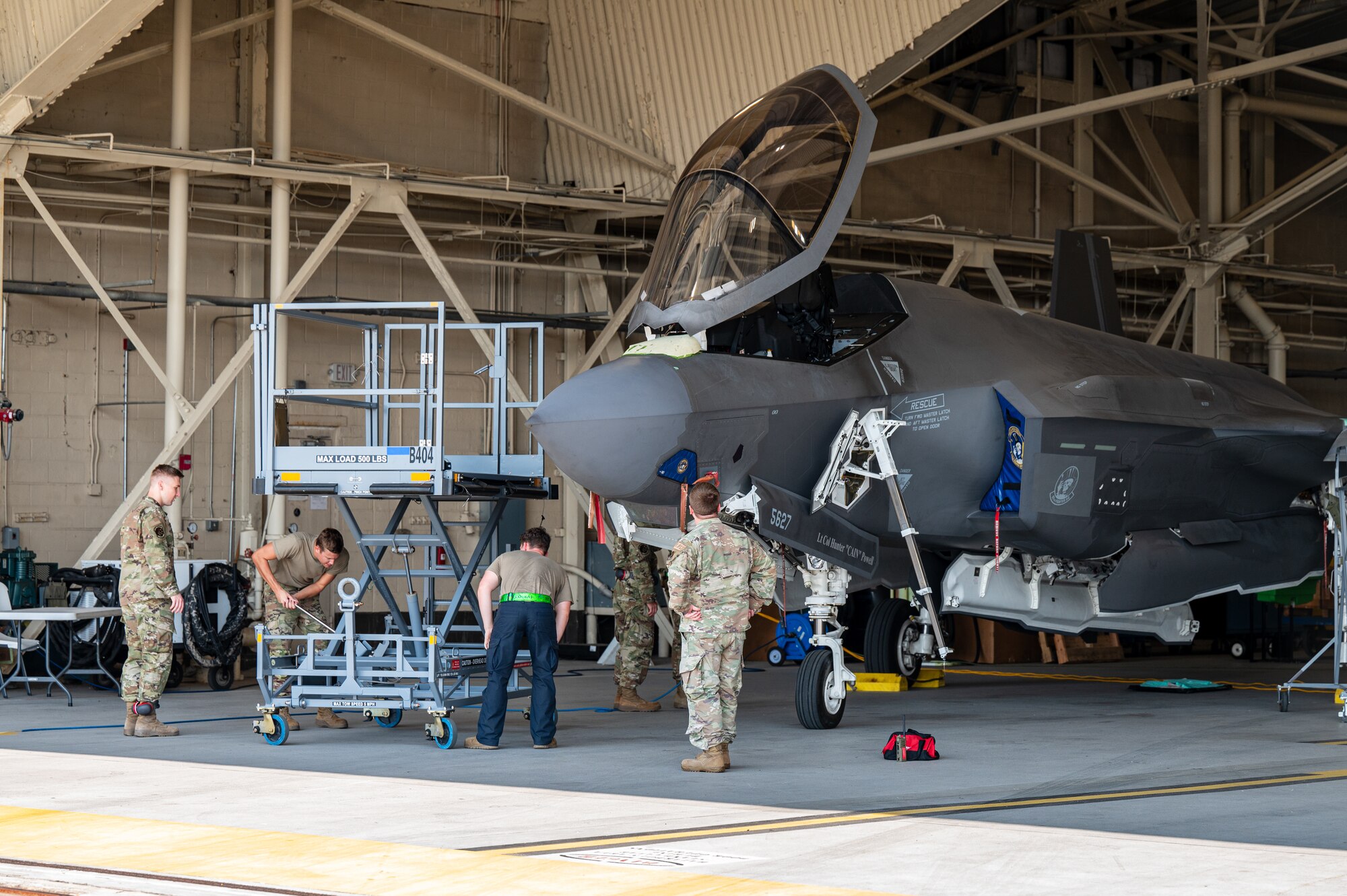 Airmen prepare to work on an aircraft