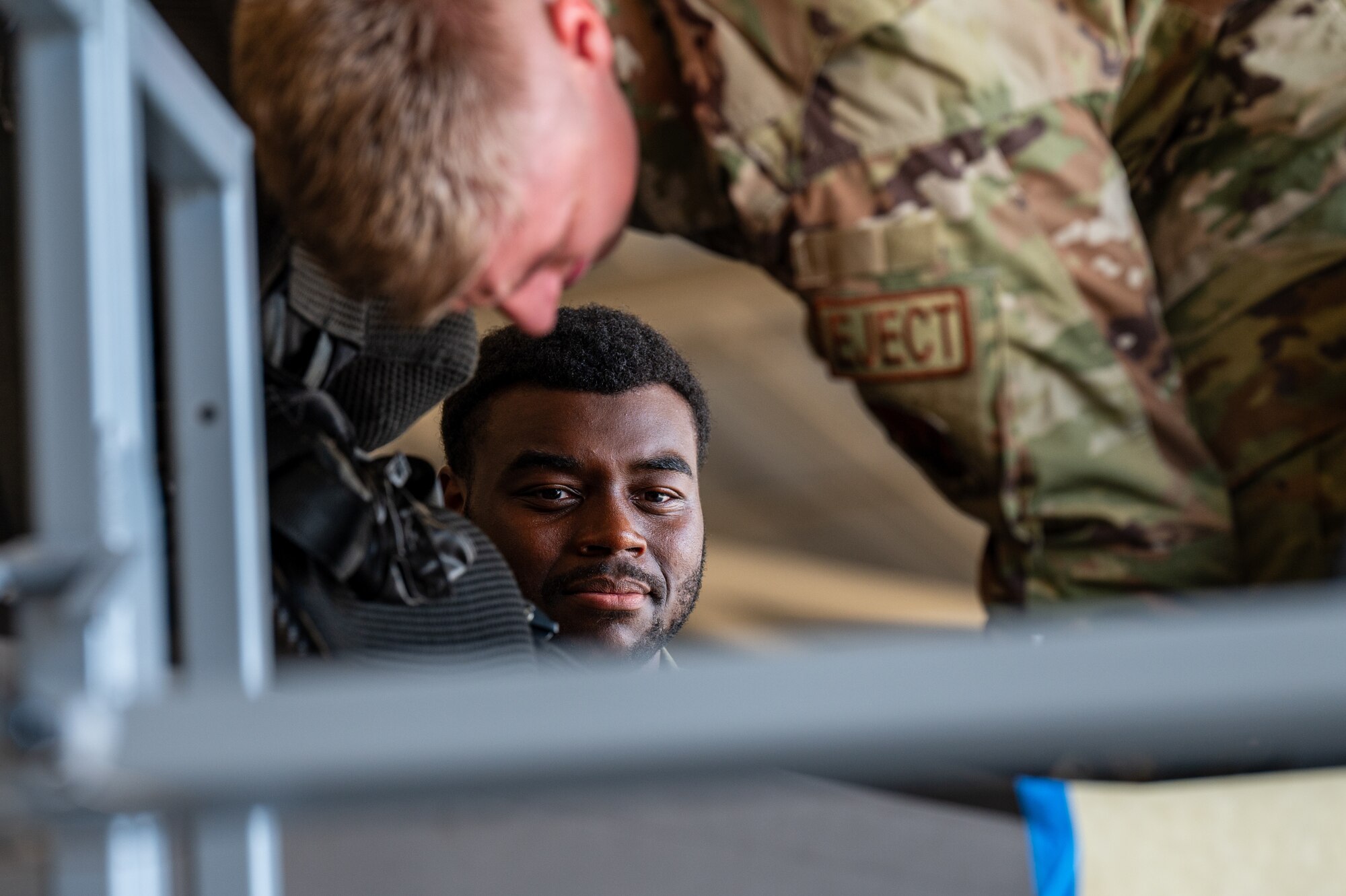 Airmen work on the cockpit of an aircraft