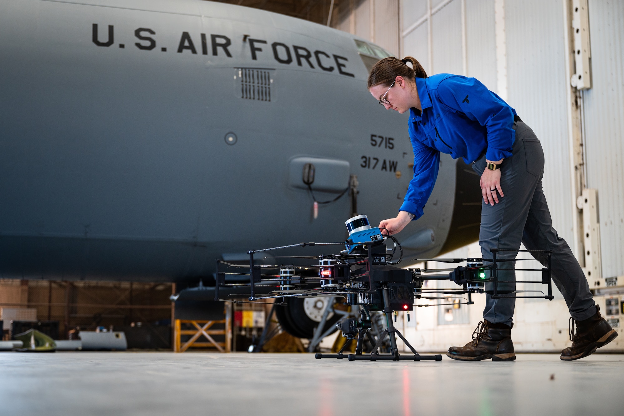 Sophie LeGore, Near Earth Autonomy flight test pilot, sets up NEA’s Customized Action Drone AD-8+ at Dyess Air Force Base, Texas, Aug. 14, 2024. Boeing and innovative small business partners operated Autonomous Small Unmanned Aircraft Systems to capture imagery and utilize Boeing’s Automated Damage Detection Software. The ADDS algorithm analyzes exterior aircraft images and detects anomalies such as missing rivets, delamination, corrosion and surface layer damage that may not be easily seen by Airmen. Boeing’s Dyess visit showcased how their partnerships can improve base operations. (U.S. Air Force photo by Airman 1st Class Jade M. Caldwell)