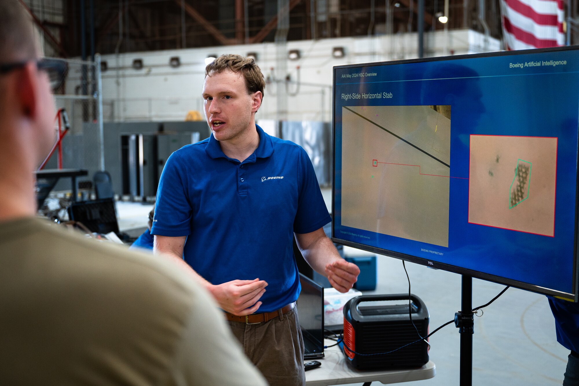 Peter Rhodes, Boeing artificial intelligence engineer, explains Boeing’s Automated Damage Detection Software to Dyess personnel at Dyess Air Force Base, Texas, Aug. 14, 2024. Partnering with Boeing allowed Autonomous Small Unmanned Aircraft Systems to photograph aircraft for consistently efficient inspections. Boeing’s ADDS algorithm cuts general visual inspection time by over 50% and increases anomaly detection rate from 50 to 94%. This partnered innovation reduces risk to Airmen, establishes a centralized digital damage record and increases aircraft availability by decreasing downtime. (U.S. Air Force photo by Airman 1st Class Jade M. Caldwell)