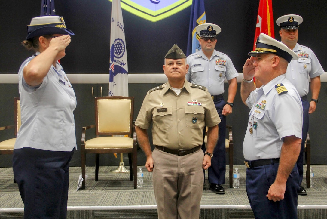 Capt. Tiffany H. Davidson (left) salutes Capt. Michael “Mac” McCarthy (right) symbolizing the assumption of command of Coast Guard Reserve Unit U.S. Southern Command during a change of command ceremony at U.S. Southern Command in Doral, Florida, Aug. 16, 2024. U.S. Coast Guard Reserve Unit Southern Command supports national security and maritime safety by providing operational and logistical support to Southern Command’s eight Joint Directorates. (U.S. Coast Guard photo by Petty Officer 3rd Class Brian Zimmerman)