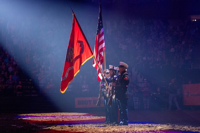U.S. Marines with Recruiting Station Oklahoma City present the national ensign and organizational colors before a Bulls, Bands & Barrels rodeo event at INTRUST Bank Arena in Wichita, Kans., Aug. 17, 2024. The rodeo was conducted to allow the local community a chance to spectate a multitude of performances, including bull riding, barrel racing, and a musical performance. (U.S. Marine Corps photo by Cpl. Maxwell Cook)