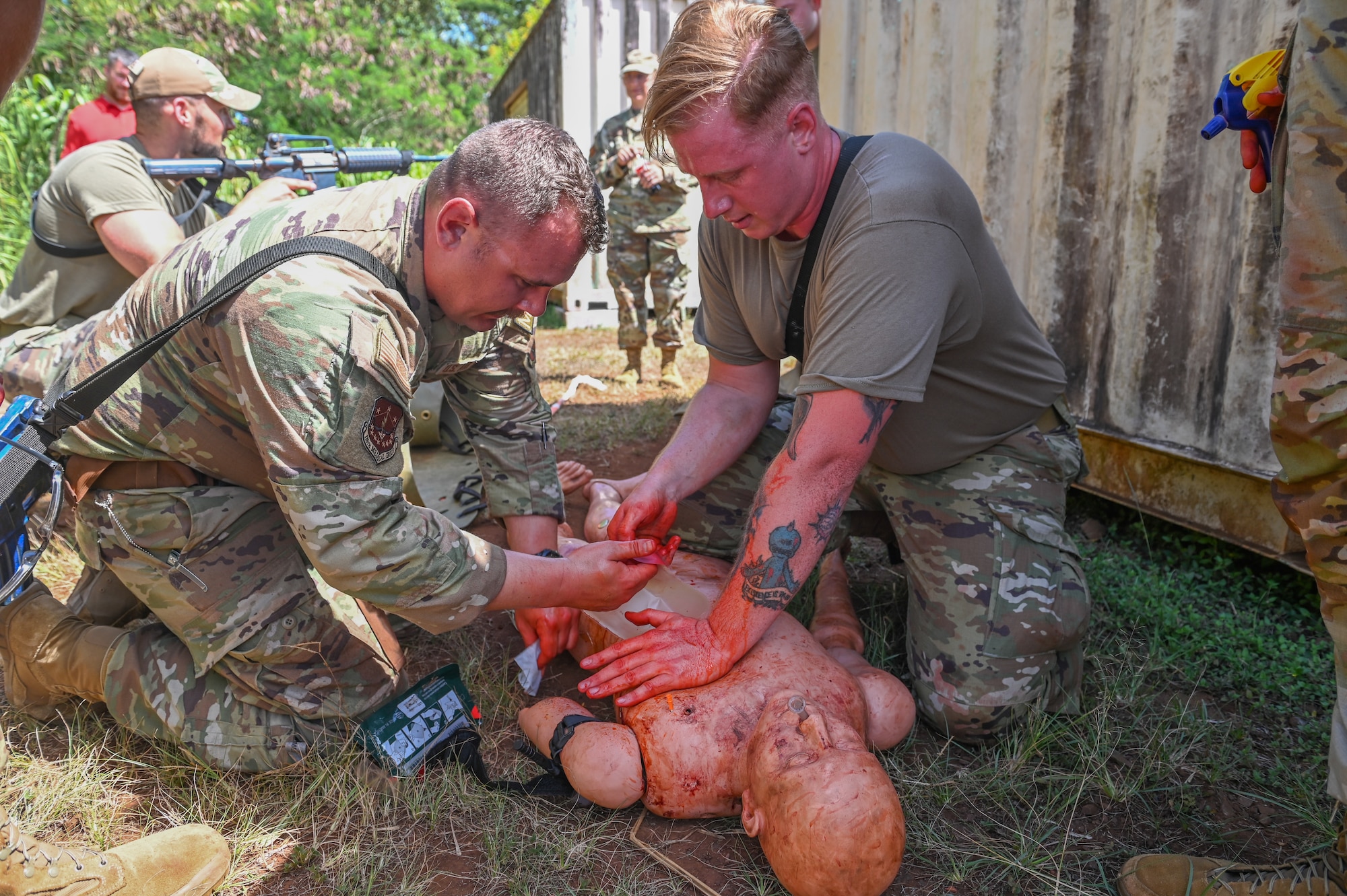 U.S. Air Force 1st Lt. Andrew Zacharias, a clinical nurse, and Staff Sgt. Grant Smurawa, an aerospace medical technician assigned to the 115th Fighter Wing Medical Group practice performing a chest seal during a Tactical Combat Casualty Care exercise July 31, 2024, at Schofield Barracks Army Base, Hawaii. Airmen assigned to the 115 MDG completed a two-week Medical Facility Annual Training on the island of Oahu to maintain mission readiness. (U.S. Air National Guard photo by Master Sgt. Mary Greenwood)