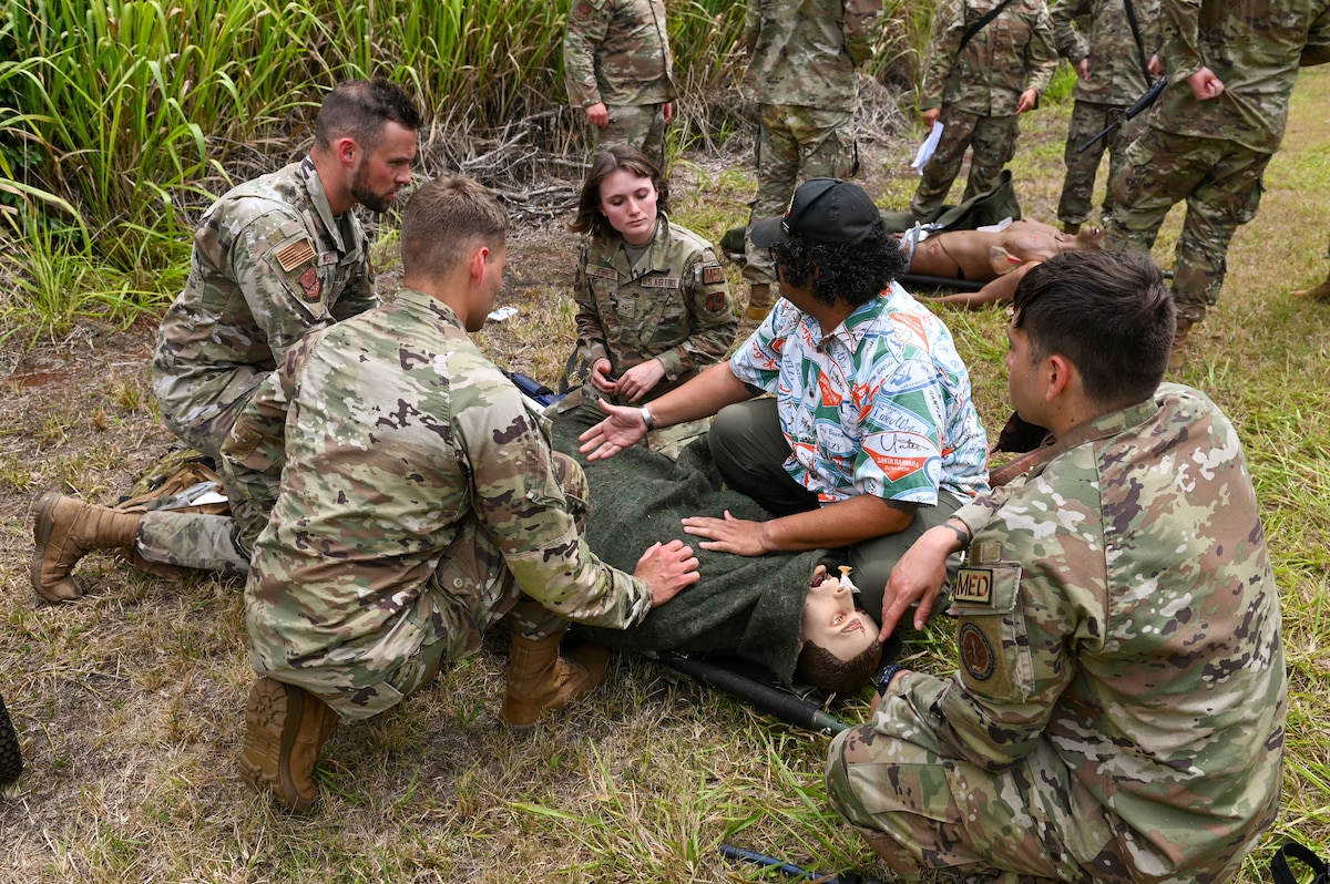 U.S. Airmen assigned to the 115th Fighter Wing train with local medics on proper patient care while under fire July 30, 2024, at Schofield Barracks Army Base,  Hawaii. Airmen assigned to the 115 MDG completed a two-week Medical Facility Annual Training on the island of Oahu to maintain mission readiness. (U.S. Air National Guard photo by Master Sgt. Mary Greenwood)