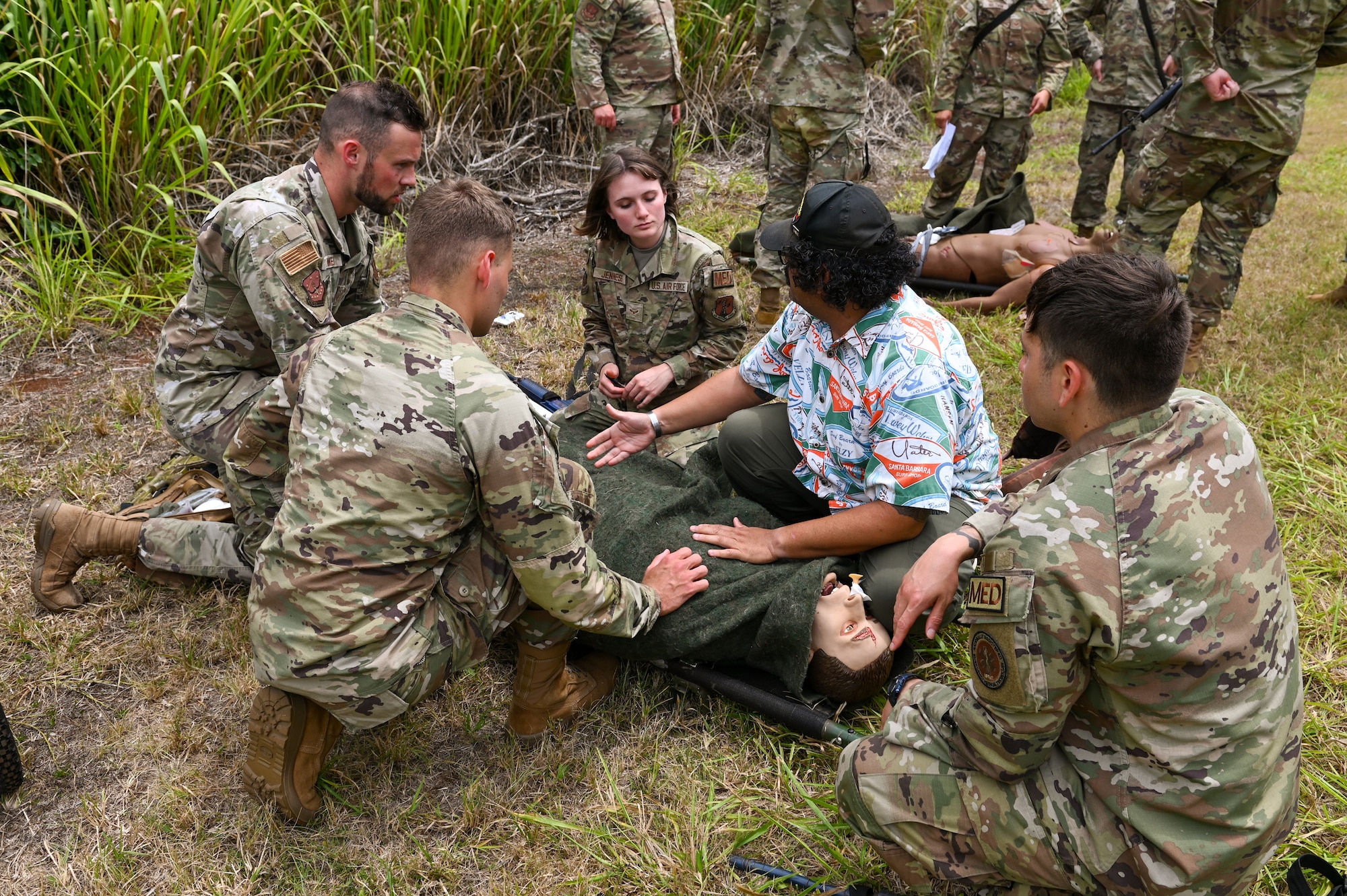U.S. Airmen assigned to the 115th Fighter Wing train with local medics on proper patient care while under fire July 30, 2024, at Schofield Barracks Army Base,  Hawaii. Airmen assigned to the 115 MDG completed a two-week Medical Facility Annual Training on the island of Oahu to maintain mission readiness. (U.S. Air National Guard photo by Master Sgt. Mary Greenwood)