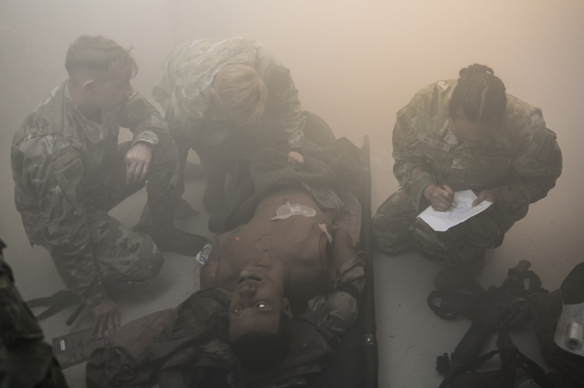 U.S. Airmen assigned to the 115th Fighter Wing practice providing medical care while under fire July 30, 2024, at Schofield Barracks Army Base, Hawaii. Airmen assigned to the 115 MDG completed a two-week Medical Facility Annual Training on the island of Oahu to maintain mission readiness. (U.S. Air National Guard photo by Master Sgt. Mary Greenwood)