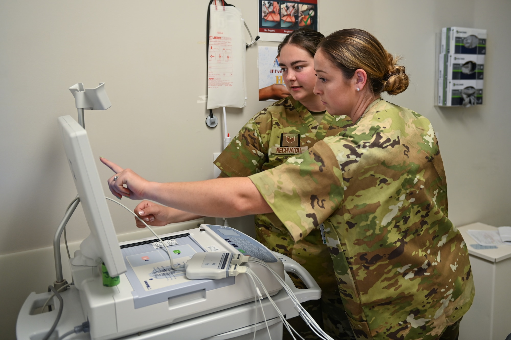U.S. Air Force Staff Sgt. Cody Nechvatal and Tech. Sgt. Brittany Reynolds, aerospace medical technicians assigned to the 115th Fighter Wing Medical Group, analyze electrocardiogram results July 22, 2024, at Tripler Army Medical Facility in Honolulu, Hawaii. Airmen assigned to the 115 MDG completed a two-week Medical Facility Annual Training on the island of Oahu to maintain mission readiness. (U.S. Air National Guard photo by Master Sgt. Mary Greenwood)