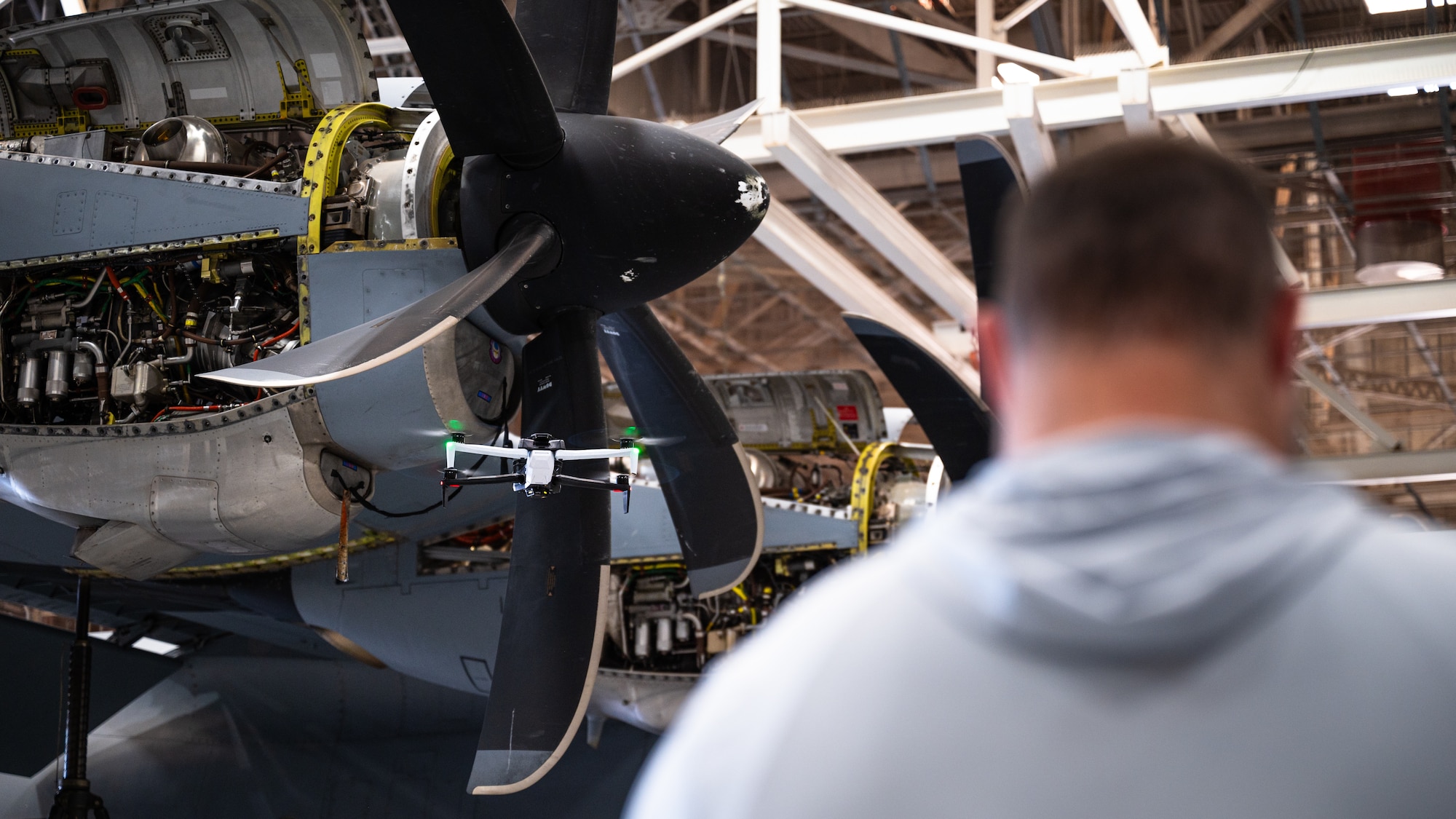Jasen Hansen, Boeing scientific photographer and drone pilot, employs a Boeing-operated Skydio X-10D to capture imagery of a C-130J Super Hercules at Dyess Air Force Base, Texas, Aug. 14, 2024. Boeing demonstrated how their partnership with small businesses change how aircraft damage can be detected. With Boeing’s Automated Damage Detecting Software, Dyess can increase aircraft availability and assess data for it’s life-cycle. The versatility of these systems allow Airmen to implement larger systems on base for consistent inspections, or use smaller systems elsewhere for quick and efficient detection. These Dyess partnerships combine innovation from small businesses with Boeing data, engineering and models all in a secure government cloud environment for Airmen. (U.S. Air Force photo by Airman 1st Class Jade M. Caldwell)