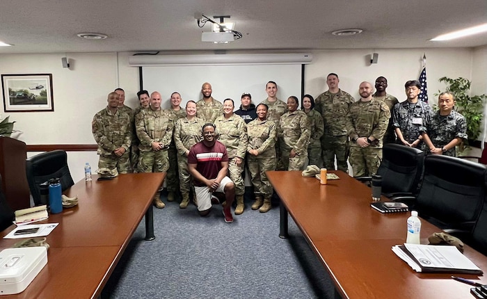 Service members pose for a photo.