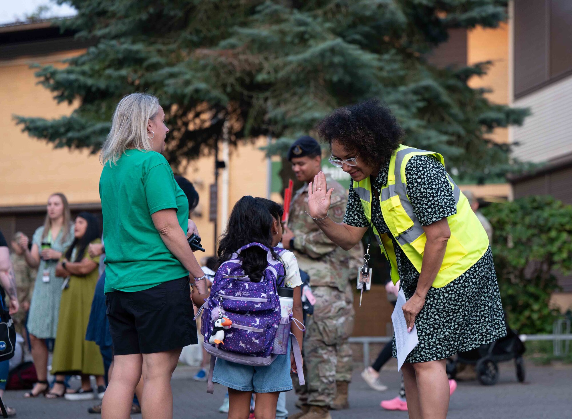 A teacher high-fives one of her new students at Ramstein Air Base, Germany, Aug. 19, 2024.
