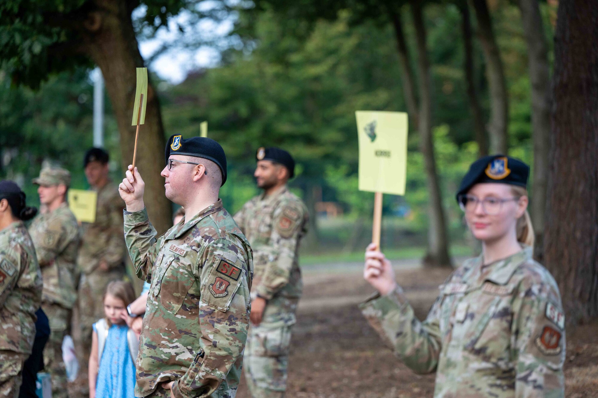 U.S. Air Force service members hold up teachers' names to guide students to their classes at Ramstein Air Base, Germany, Aug. 19, 2024.