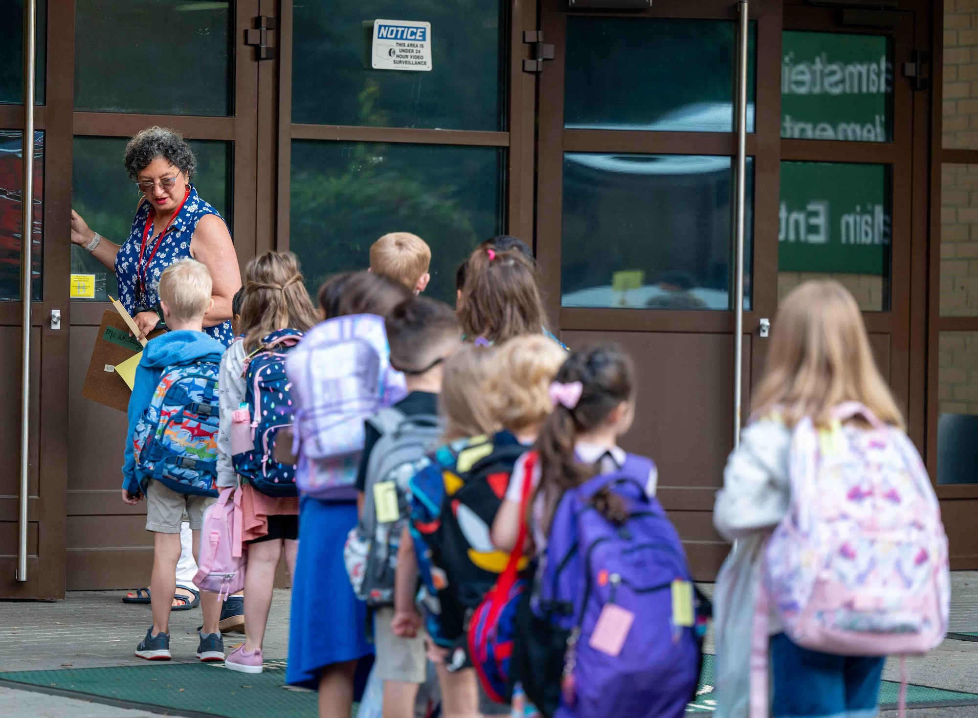 A teacher leads her new class of students to their classroom at Ramstein Air Base, Germany, Aug. 19, 2024.