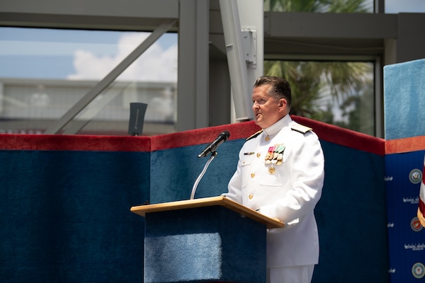 Rear Adm. Walter Brafford, commanding officer Naval Medical Forces Development Command (NMFDC) speaks to Sailors and members of the audience during a change of command ceremony for Navy Medicine Operational Training Command (NMOTC) held aboard Naval Air Station Pensacola, Aug. 14. The Command oversees six detachments and 12 training centers, with facilities in over 60 locations across the United States. These facilities support training programs in aviation, surface and undersea warfare, expeditionary forces, and special operations, providing medical training for the Navy, other U.S. armed forces, and allied nations. (U.S. Navy photo by Mass Communication Specialist 1st Class Russell Lindsey SW/AW)