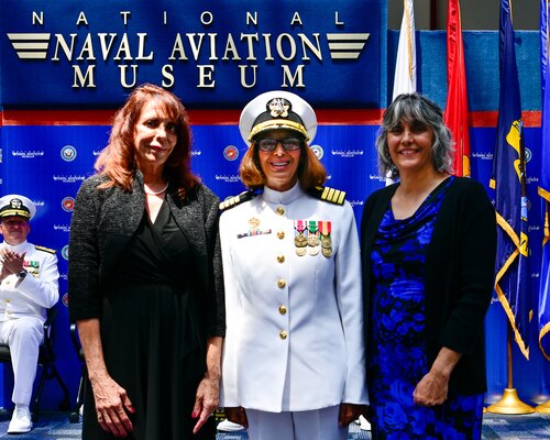 Capt. Nichole Olson, commanding officer Navy Medicine Operational Training Command (NMOTC) poses for a photo with her family during a change of command ceremony held for NMOTC aboard Naval Air Station Pensacola, Aug. 14. The Command oversees six detachments and 12 training centers, with facilities in over 60 locations across the United States. These facilities support training programs in aviation, surface and undersea warfare, expeditionary forces, and special operations, providing medical training for the Navy, other U.S. armed forces, and allied nations. (U.S. Navy photo by Mass Communication Specialist 1st Class Russell Lindsey SW/AW)