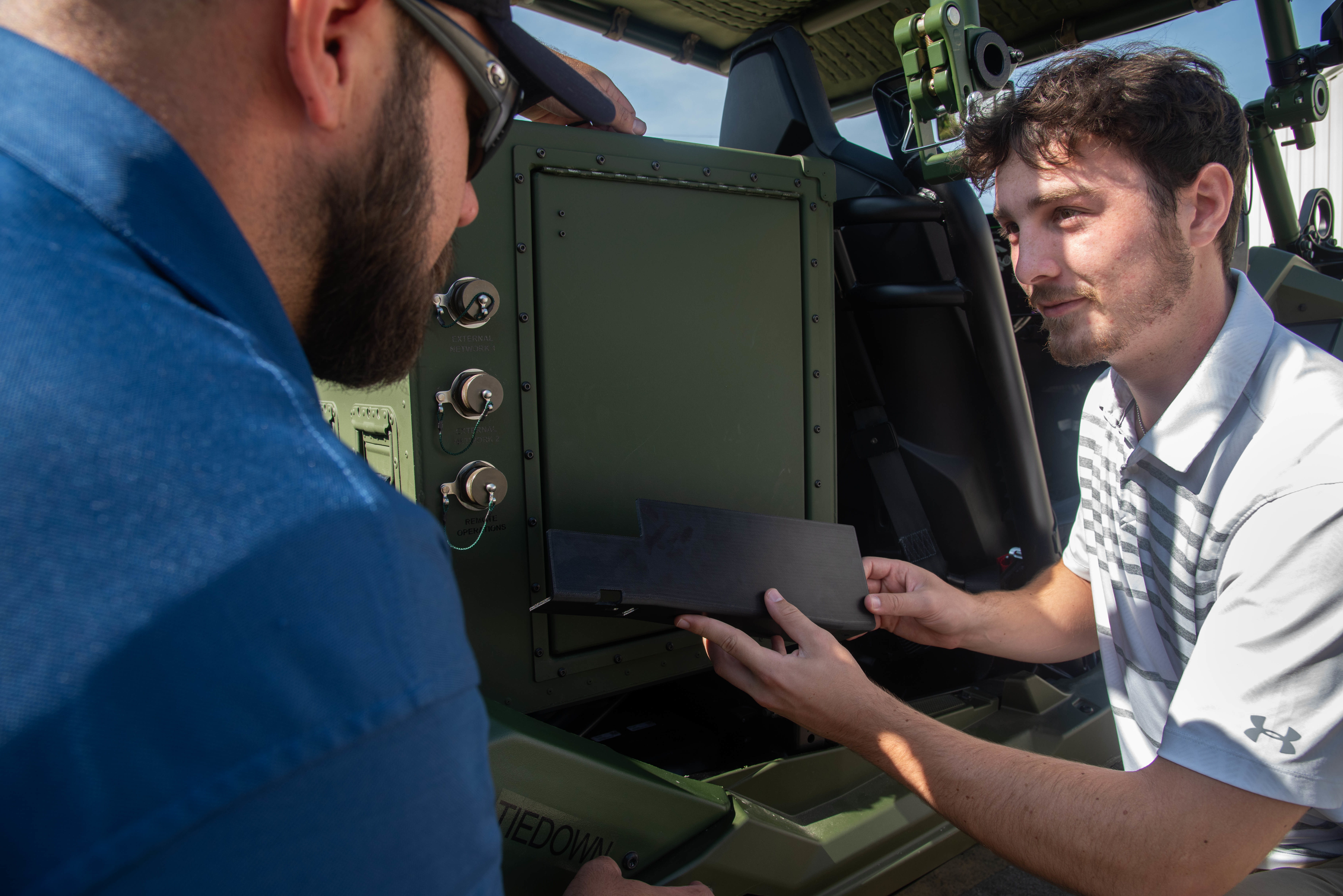Naval Information Warfare Center (NIWC) Atlantic student intern Miles Turk discusses installing a part he designed and 3D printed. NIWC hosted 94 talented student interns this summer in support of continued learning in STEM and furthering innovation in the information warfare battlespace. Interns got hands-on experience in multiple areas installation and integration of software, cyber operations development for mobile devices, server configuration, vulnerability testing and more. The NIWC Atlantic Student Intern program is designed to provide an internship for students currently enrolled in school at a collegiate level. Students follow a developmental plan that provides a roadmap for potential future employment at NIWC Atlantic.