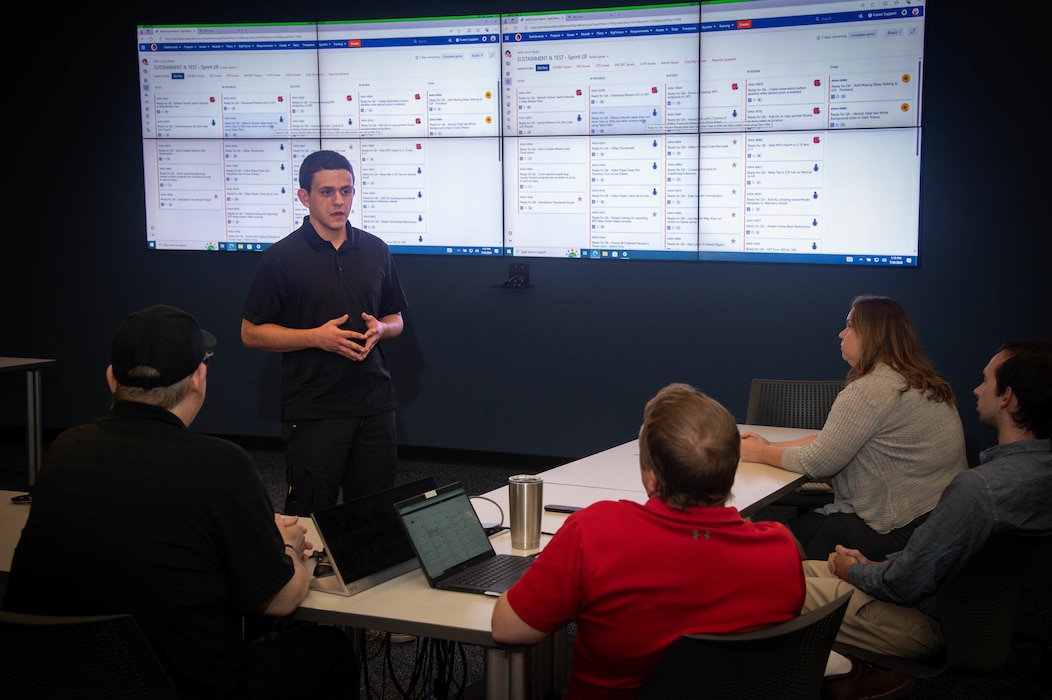 Naval Information Warfare Center (NIWC) Atlantic student intern Riley Osborne briefs his team members about the project he's working on. NIWC hosted 94 talented student interns this summer in support of continued learning in STEM and furthering innovation in the information warfare battlespace. Interns got hands-on experience in multiple areas installation and integration of software, cyber operations development for mobile devices, server configuration, vulnerability testing and more. The NIWC Atlantic Student Intern program is designed to provide an internship for students currently enrolled in school at a collegiate level. Students follow a developmental plan that provides a roadmap for potential future employment at NIWC Atlantic.