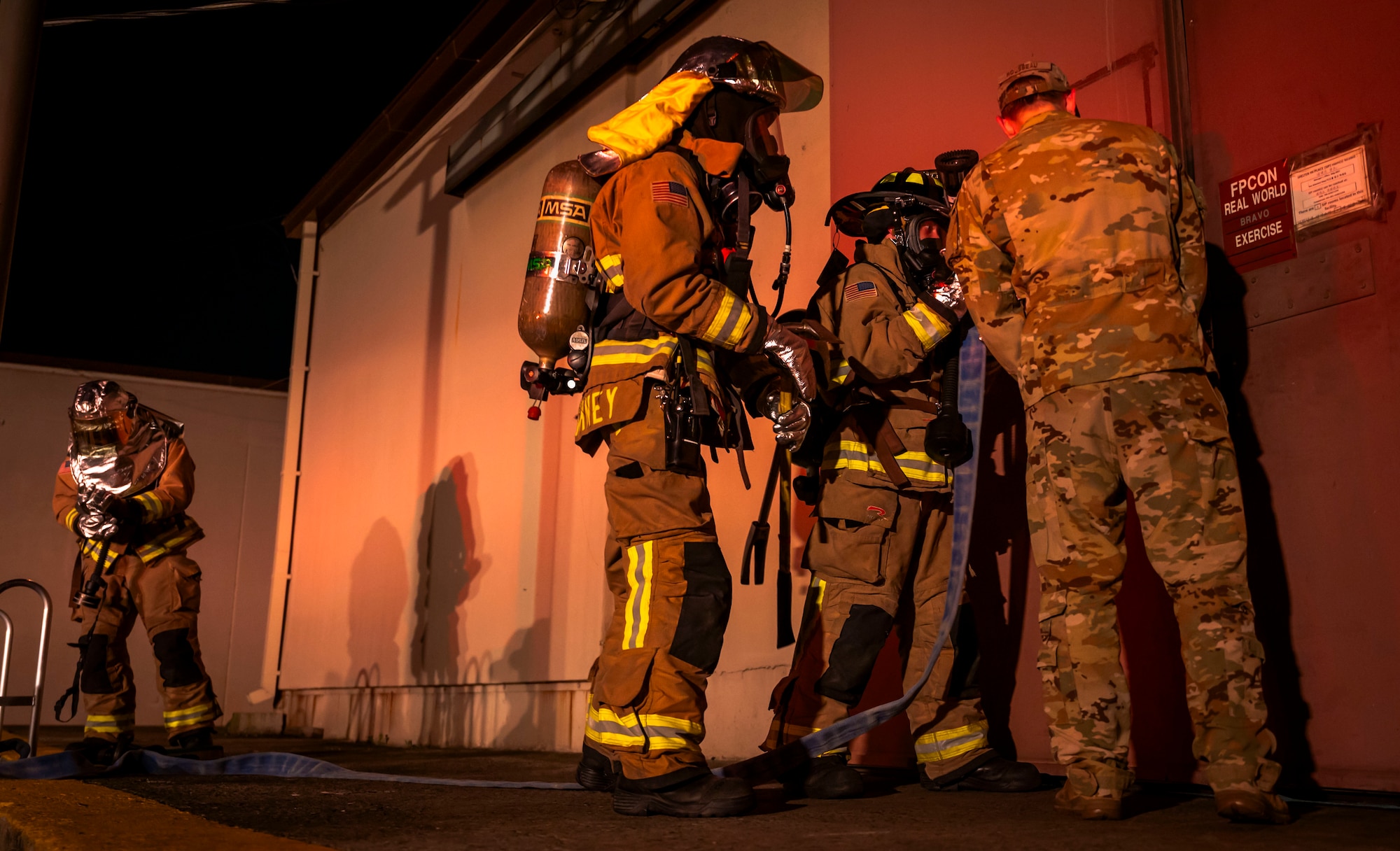 U.S. Air Force firefighters assigned to the 51st Civil Engineer Squadron unlock a door to extinguish a simulated fire during Ulchi Freedom Shield 24 at Osan Air Base, Republic of Korea, Aug. 18, 2024. The training provided 51st CES crew members the opportunity to apply knowledge and skills essential for contingency operations. UFS24 is an annual combined exercise conducted in support of the U.S.-ROK Mutual Defense Treaty that highlights the U.S. commitment to the alliance. (U.S. Air Force photo by Senior Airman Sabrina Fuller-Judd)