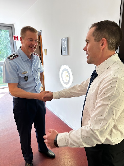 LEAP Scholar Maj. Kenneth Hynes (right) presents the Air Force Culture and Language Center coin, as a thank you, to Col. Ilg, Director of Training and Deputy Commander of the Bundeswehr Command and Staff College, Hamburg during a Cyber Language Intensive Training Event (LITE) in Germany.