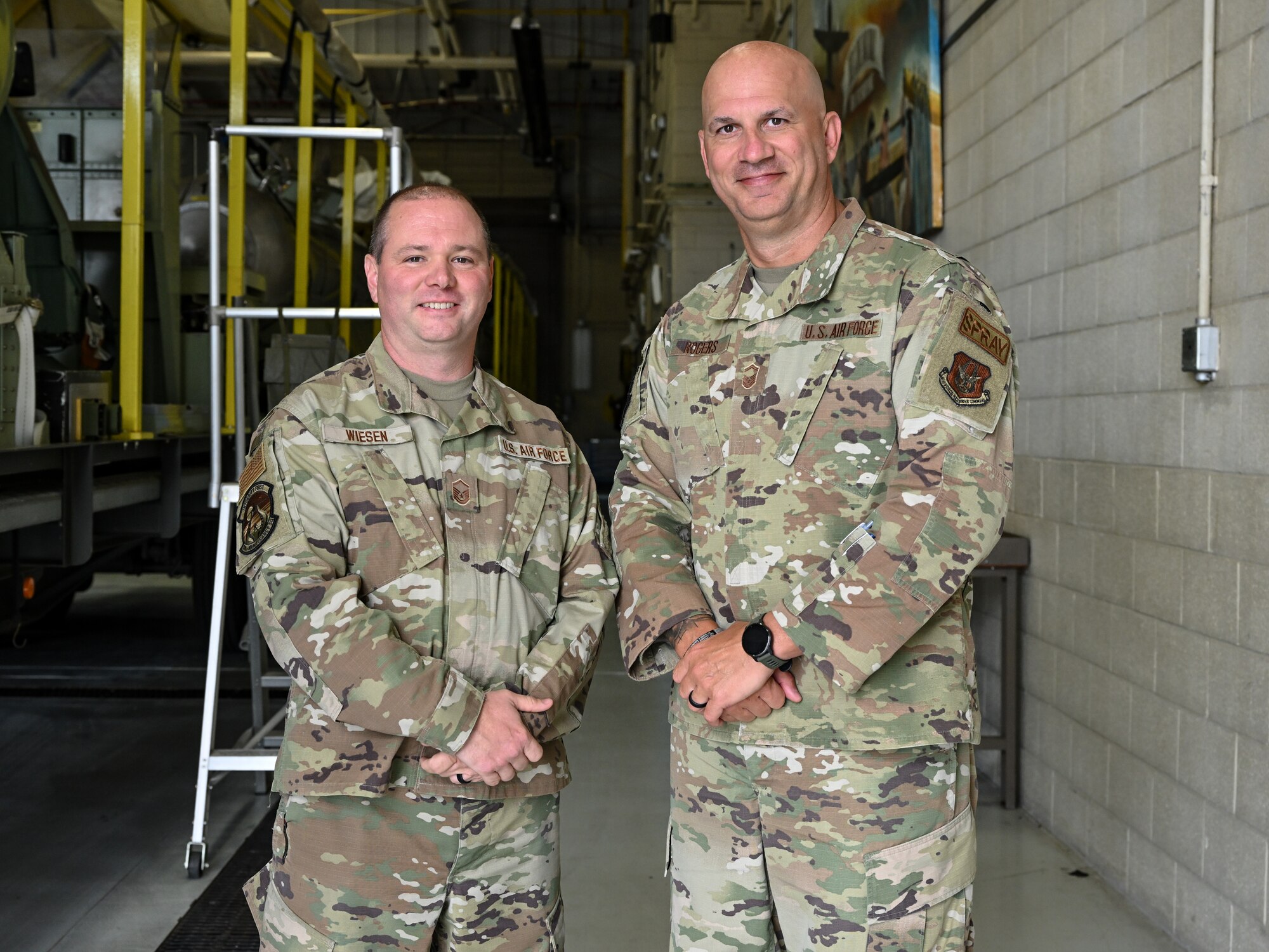 Master Sgt. Thomas Wiesen, 910th Aerial Spray maintainer, and Senior Master Sgt. Jeremy Rogers, 910th Aerial Spray Maintenance flight chief, pose for a photo at Youngstown Air Reserve Station, Ohio, August 20, 2024.