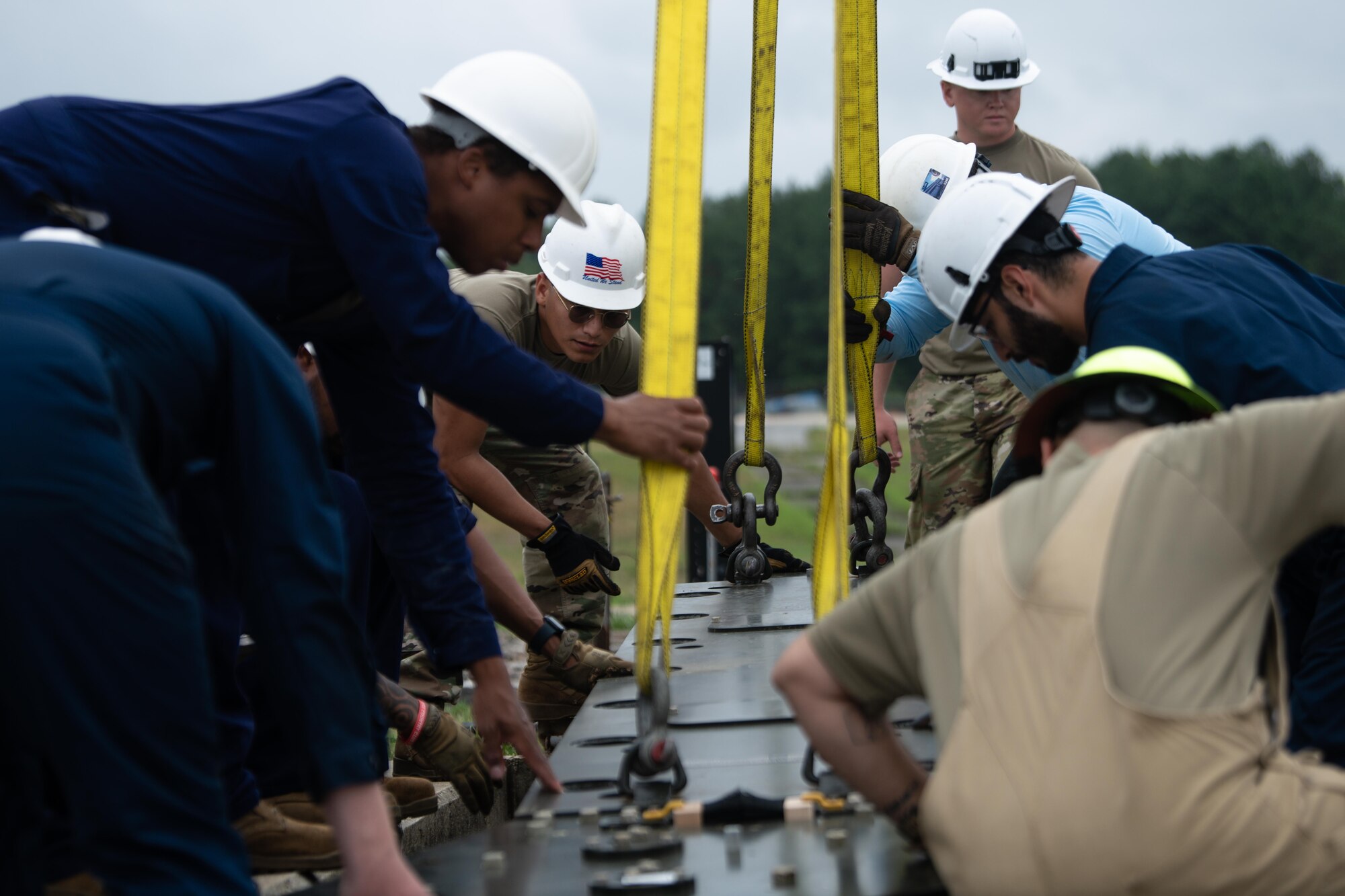 Members with the 316th Civil Engineer Squadron place a fairlead beam during the overhaul of the BAK-12 aircraft arresting system.