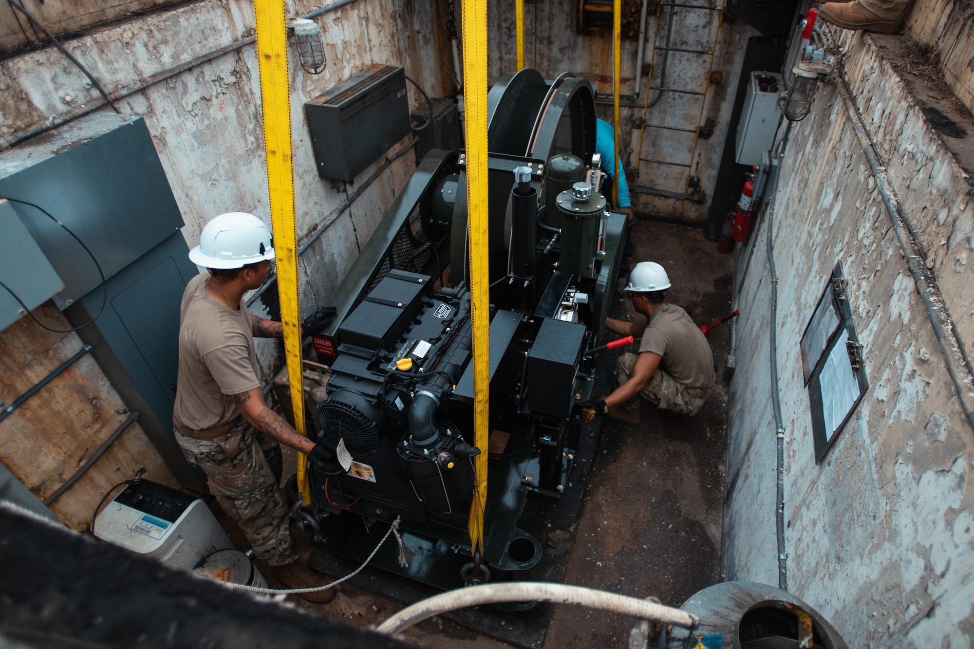 Airman with the 316th Civil Engineer Squadron maneuver the aircraft arresting system into its housing.
