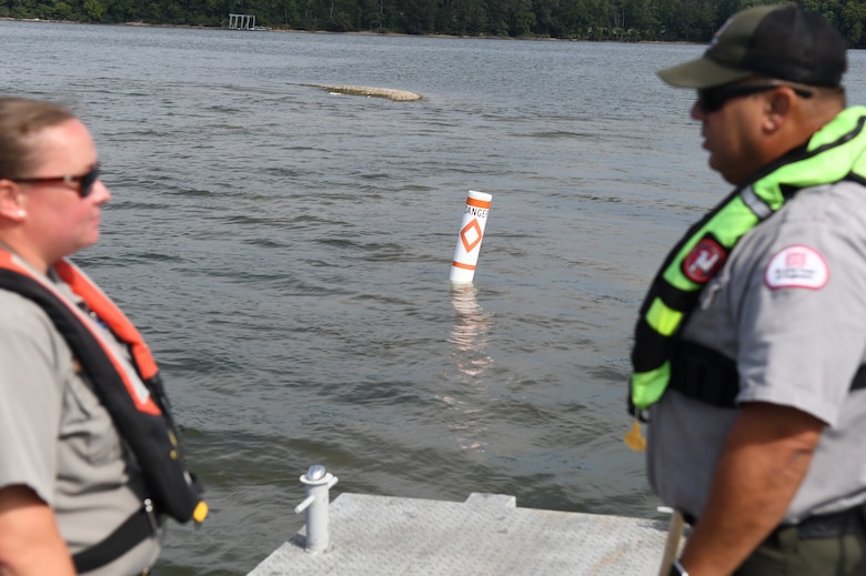 U.S. Army Corps of Engineers Rangers Danielle Packer (left) and David Landis (right) discuss the position of the next buoy after placing a danger buoy at Lake Barkley in Kuttawa, Kentucky, Aug. 14, 2024,