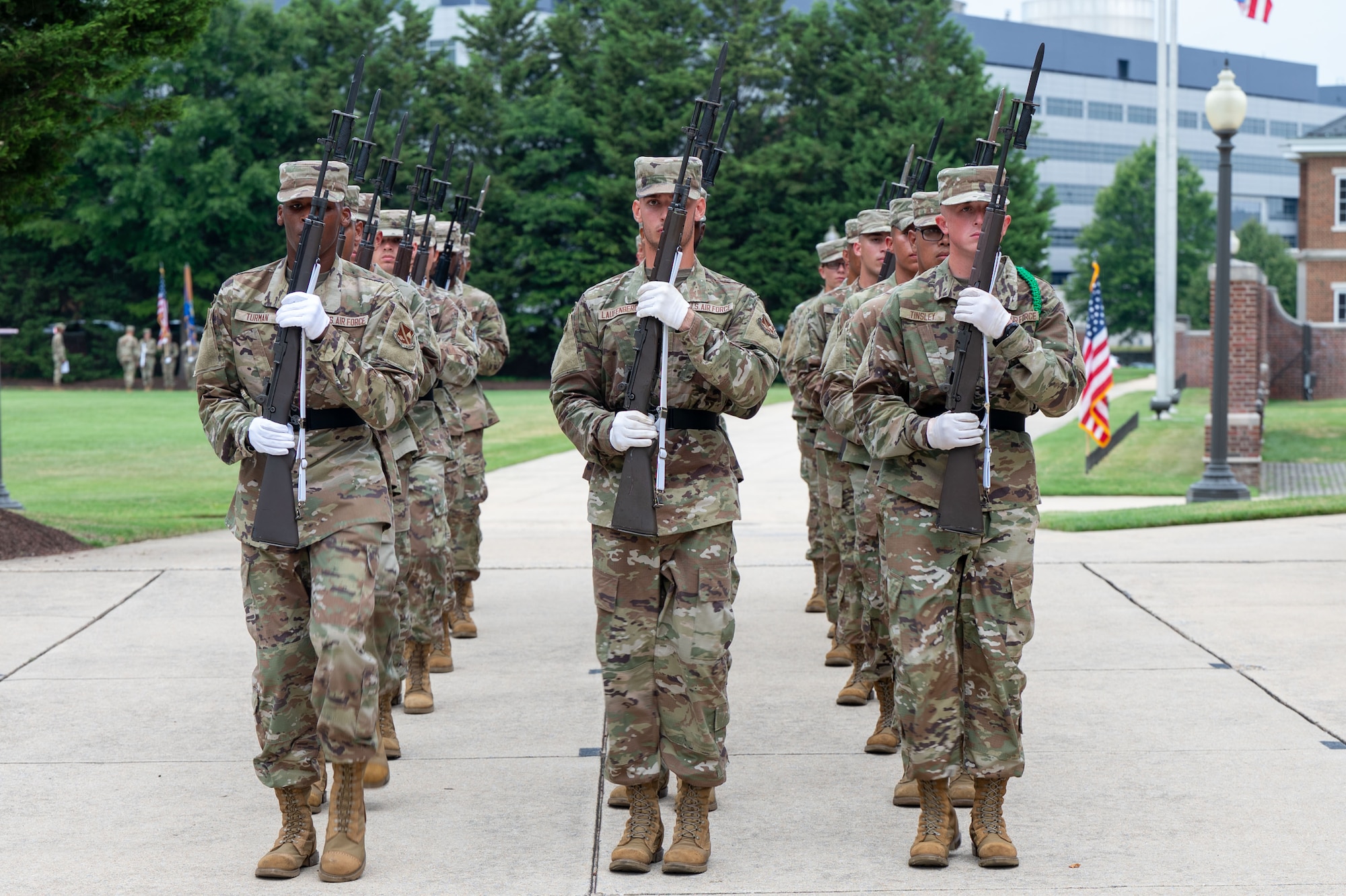 Military trainees from the U.S. Air Force and U.S. Space Force come to a halt after marching around the campus
