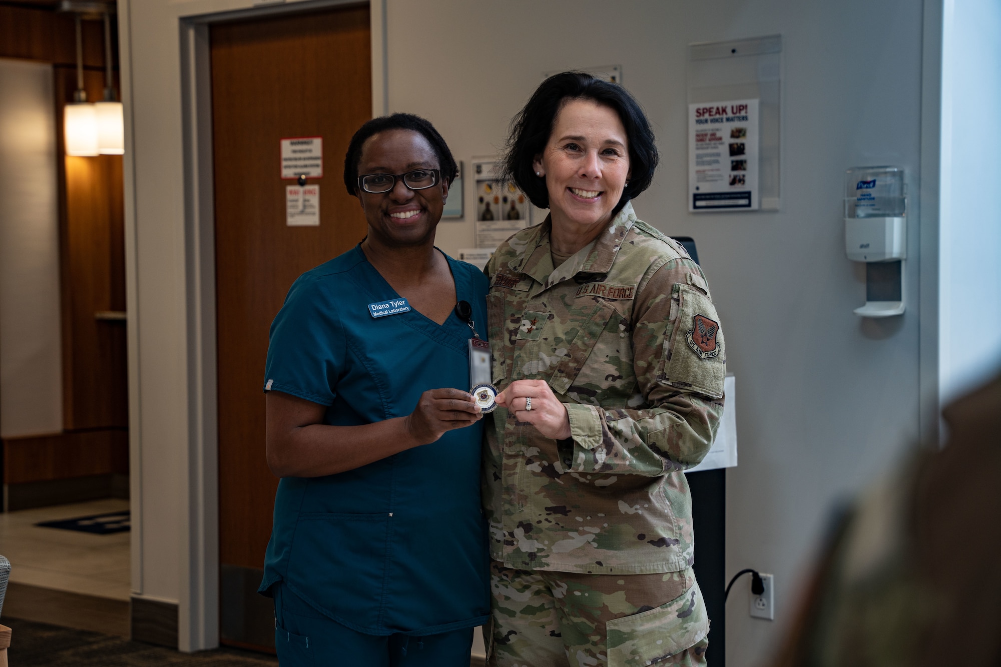 U.S. Air Force Maj. Gen. Jeannine M. Ryder, commander of Air Force Medical Agency, director of the Defense Health Network Continental, coins a member at the 27th Special Operations Medical Group during an immersion at Cannon Air Force Base, New Mexico, Aug. 12, 2024. Wing leadership provided Maj. Gen. Ryder an immersion to the 27th SOW’s unconventional mission, Cannon AFB’s unique medical challenges and ongoing initiatives to address them. (U.S. Air Force photo by Senior Airman Mateo Parra)