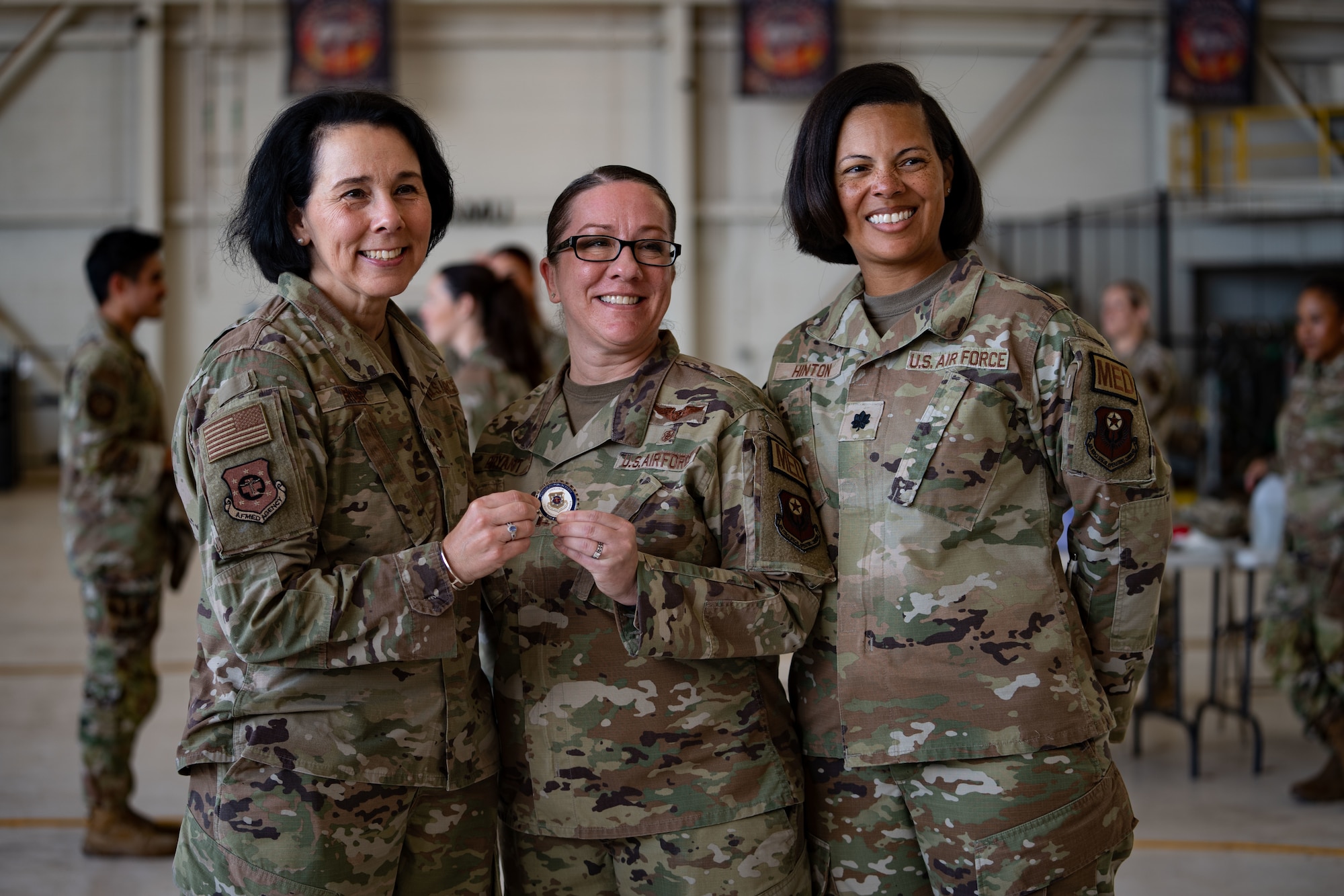 U.S. Air Force Maj. Gen. Jeannine M. Ryder, commander of the Air Force Medical Agency and director of the Defense Health Network Continental, coins a 27th Special Operations Wing Air Commando at the opening ceremony of Medic Rodeo 2024 at Cannon Air Force Base, New Mexico, Aug. 12, 2024. Medic Rodeo creates a ready medical force through realistic training as it provides a platform for medics across the Air Force to train and test for proficiency in new and emerging threats. (U.S. Air Force photo by Senior Airman Mateo Parra)