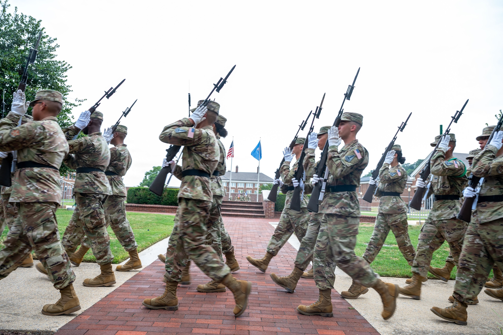 U.S. Air Force Airmen and U.S. Space Force Guardians march in the squadron area of the United States Air Force Honor Guard headquarter