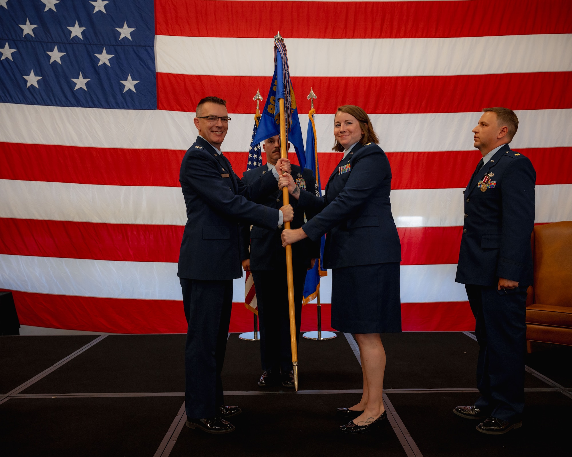 Col. Kevin Brown passes the guidon to Maj. Jenna Donaldson.