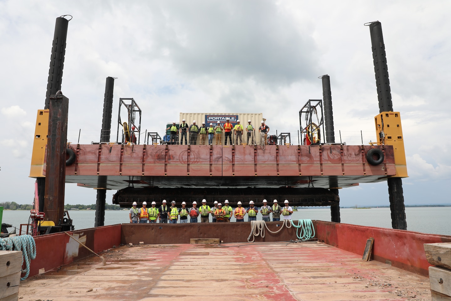The U.S. Army Corps of Engineers, Detroit District, removed a spare set of miter gates, constructed for the Davis and Sabin Locks, from the St. Marys River this summer. The miter gates were hidden in the river for over 80 years and weighed about 350,000 pounds each. 
The gates were strategically stored downriver of the Soo Locks facility and out of the federal navigation channel in the 1940s during World War II. The purpose of storing the gates downriver was to have a spare set of replacement gates for either lock if the installed gates were damaged. 
About 40 Soo Project Office employees worked on the project from beginning to end, shown are about half of the employees.