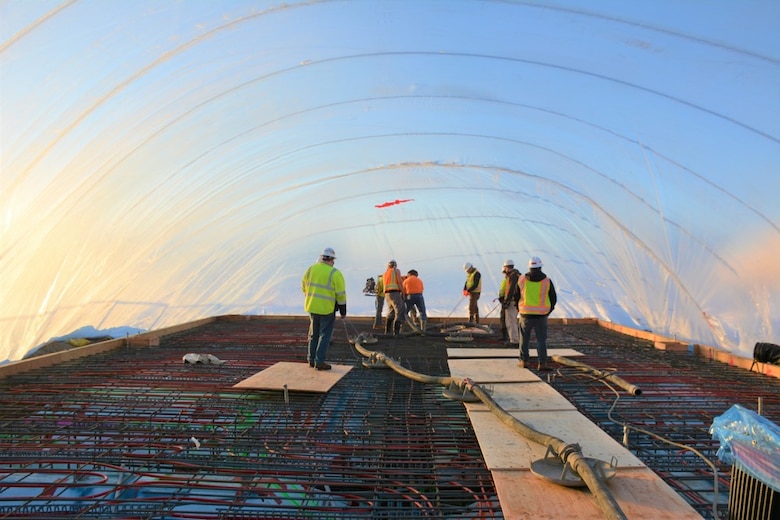 Since 1946, the Alaska District has served as the nation’s leader in arctic engineering and construction. During the beddown, engineers and construction personnel applied extensive cold regions expertise to the F-35 projects. Shown here, construction crews work underneath a covered canopy during the winter months.