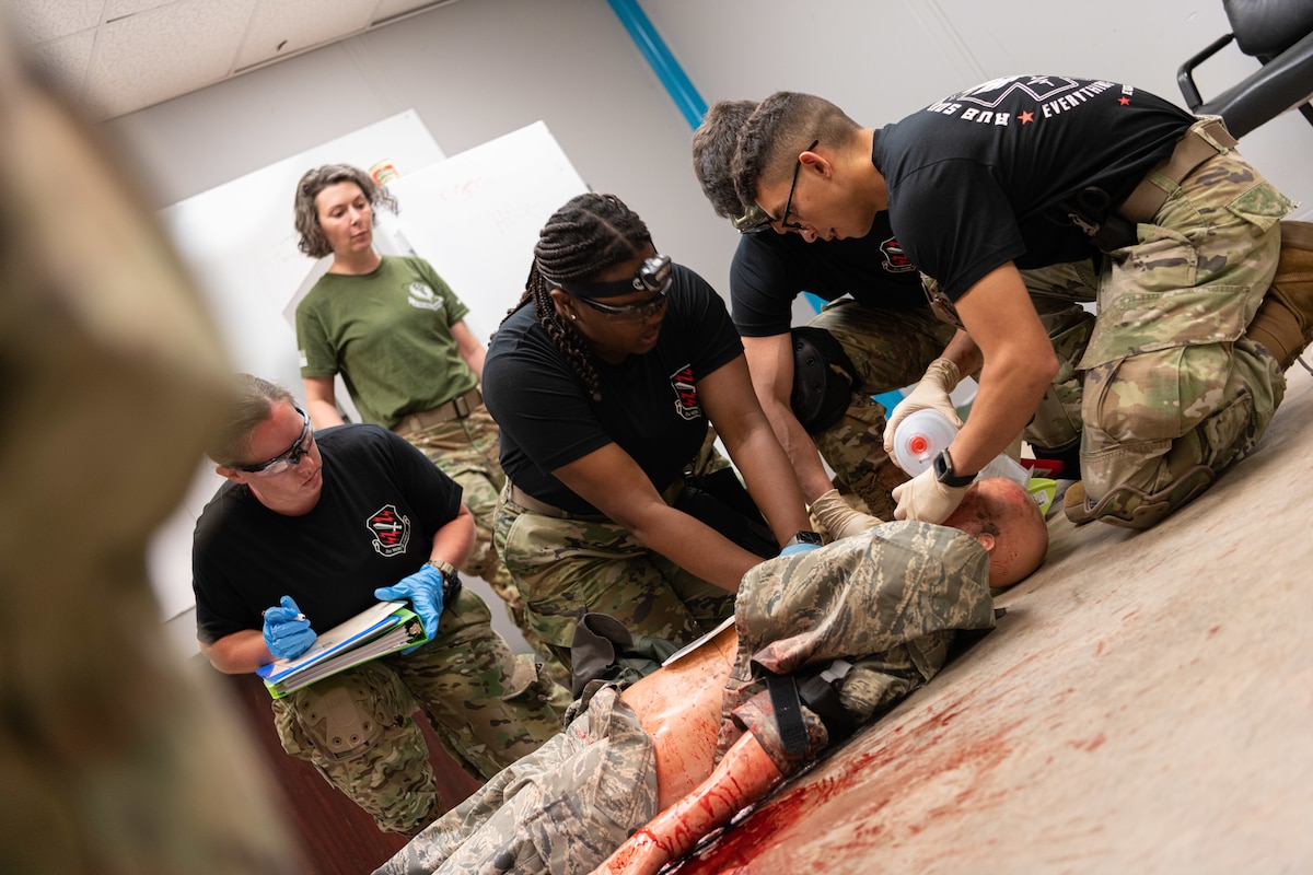 U.S. Air Force Airmen assigned to the 21st Medical Group, Peterson Space Force Base, Colorado, provide tactical combat casualty care to a simulated trauma victim during exercise Medic Rodeo at Cannon Air Force Base, New Mexico, Aug. 13, 2024. In accordance with the Medic-X strategic initiative, every Air Force medic, including those not directly involved in patient care, needs to be proficient in 52 skills that ensure the Air Force's medical force is ready for the next fight. (U.S. Air Force photo by Senior Airman Drew Cyburt)
