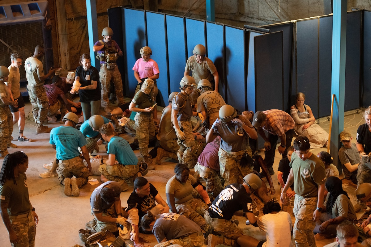U.S. Airmen participate in a mass casualty exercise during Medic Rodeo at Cannon Air Force Base, New Mexico, Aug. 15, 2024. The exercise surprised the exhausted participants as they had to work together to attempt to save nearly 50 simulated casualties. (U.S. Air Force photo by Senior Airman Drew Cyburt)