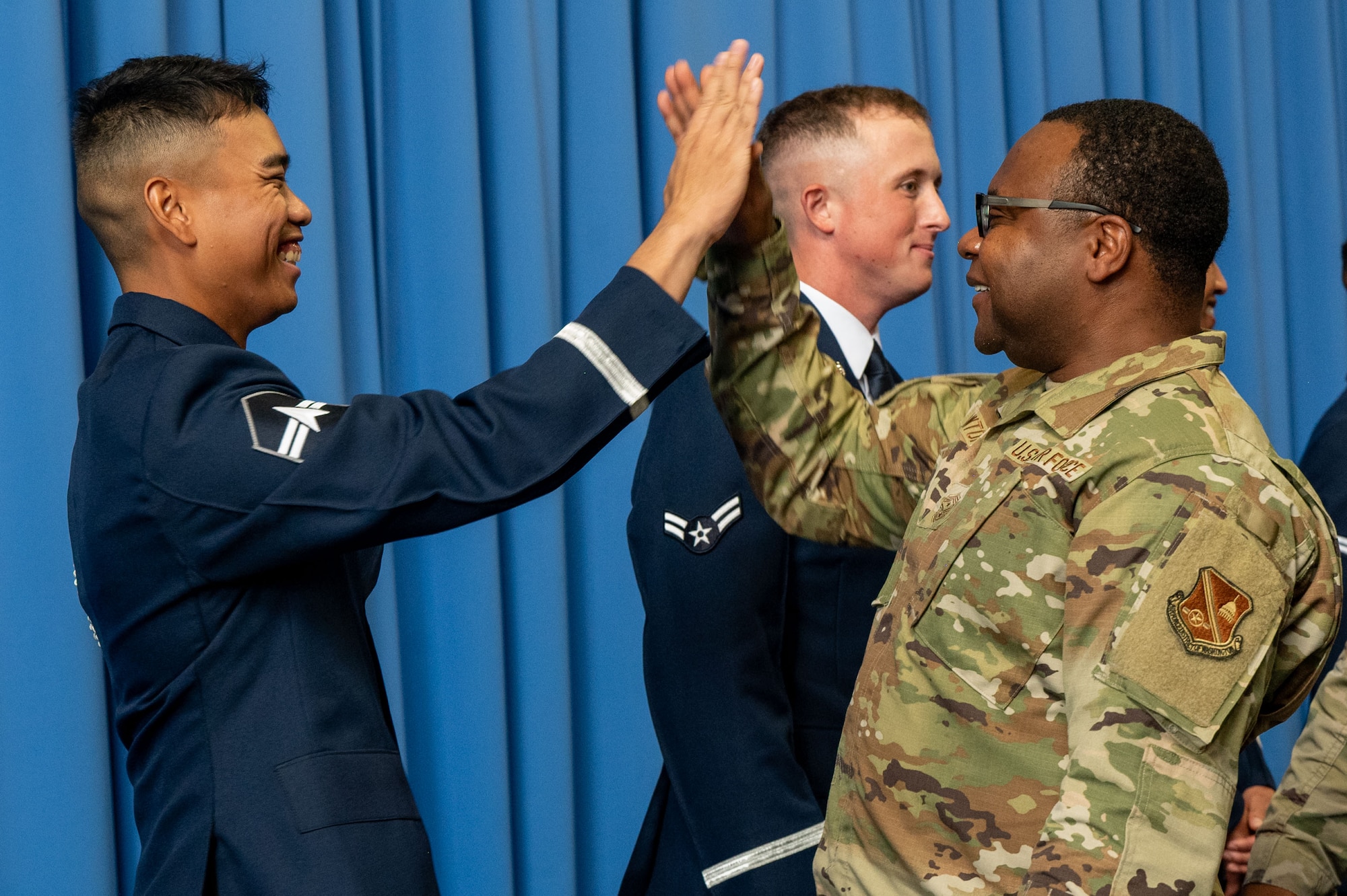 U. S. Space Force Spc. 3 Cian De Leon gets a congratulatory “high-five” from U.S. Air Force Chief Master Sgt. Clifford L. Lawton