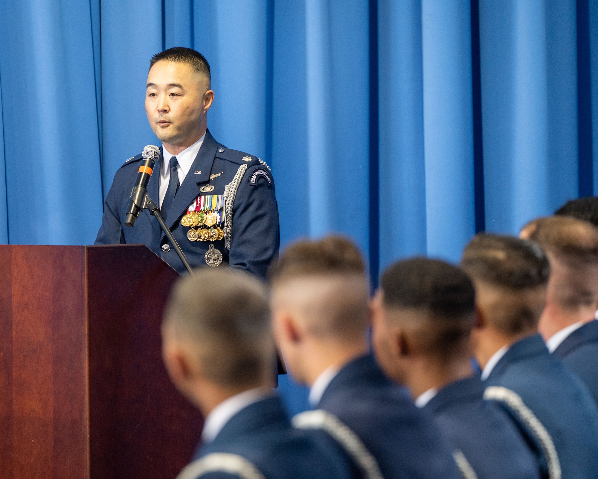 Air Force Honor Guard Commander at podium
