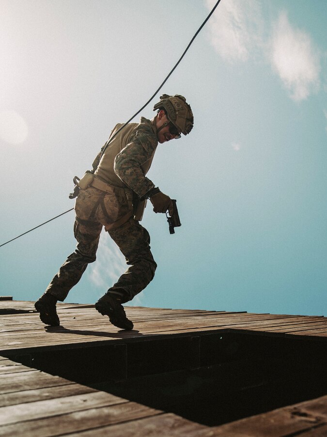 A U.S. Marine assigned to Reconnaissance Company, 15th Marine Expeditionary Unit, practices clearing a window while rappelling during mountain rescue training led by Republic of Korea Marines at ROK Marine Corps Base Pohang, South Korea, Aug. 16, 2024. Integrated training between the two countries strengthens the ROK-U.S. Alliance through bilateral, joint training, contributing toward combined capability in defense of the Korean Peninsula. (U.S. Marine Corps photo by Cpl. Joseph Helms)