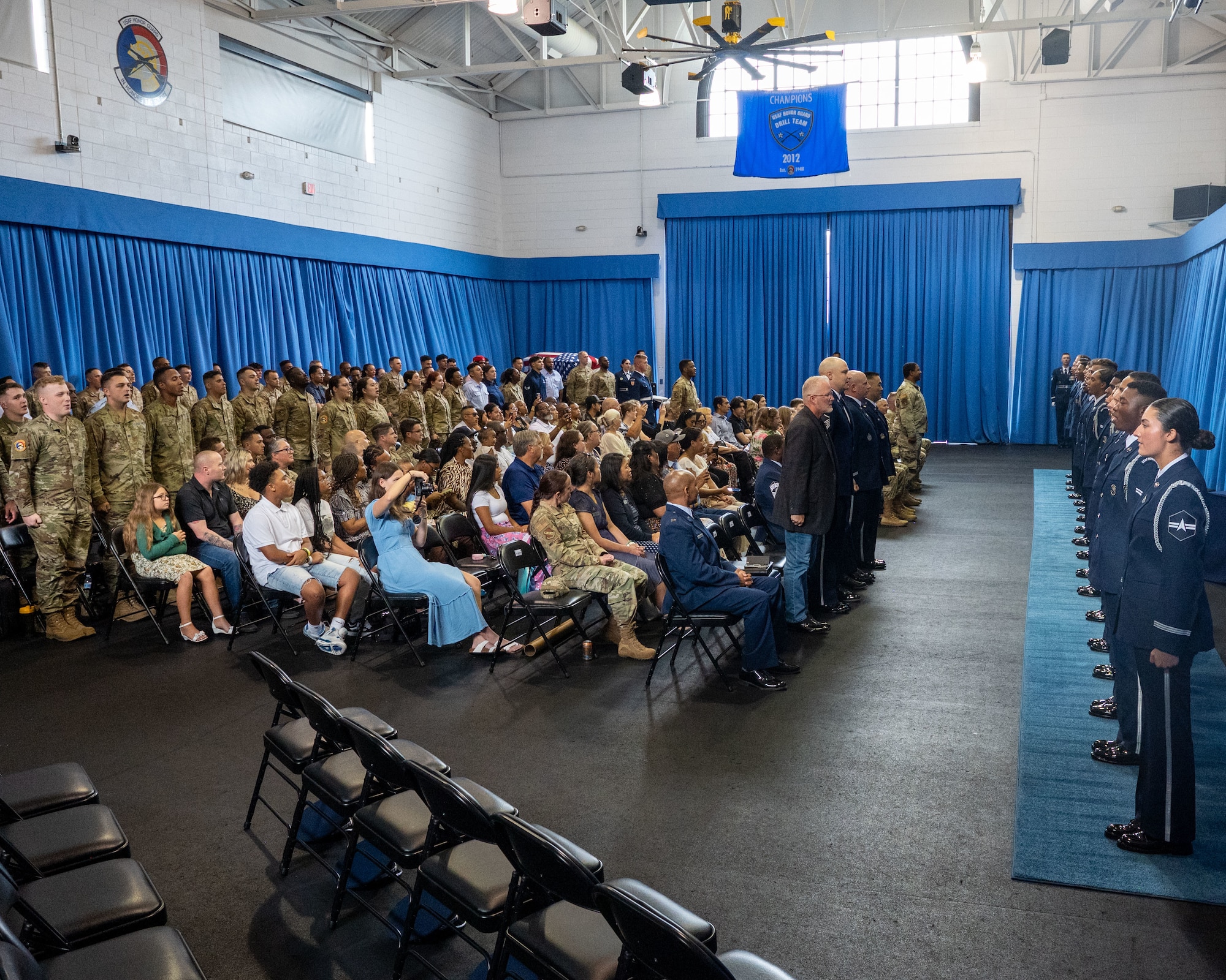 Eighteen new ceremonial guardsmen, 12 U.S. Air Force Airmen and six U.S. Space Force Guardians, stand before an enthusiastic crowd during a momentous U.S. Air Force Honor Guard graduation ceremony