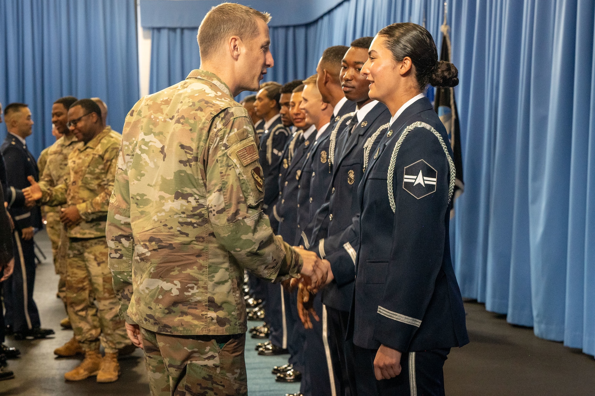 Air Force Col. shakes hands with Space Force Guardian
