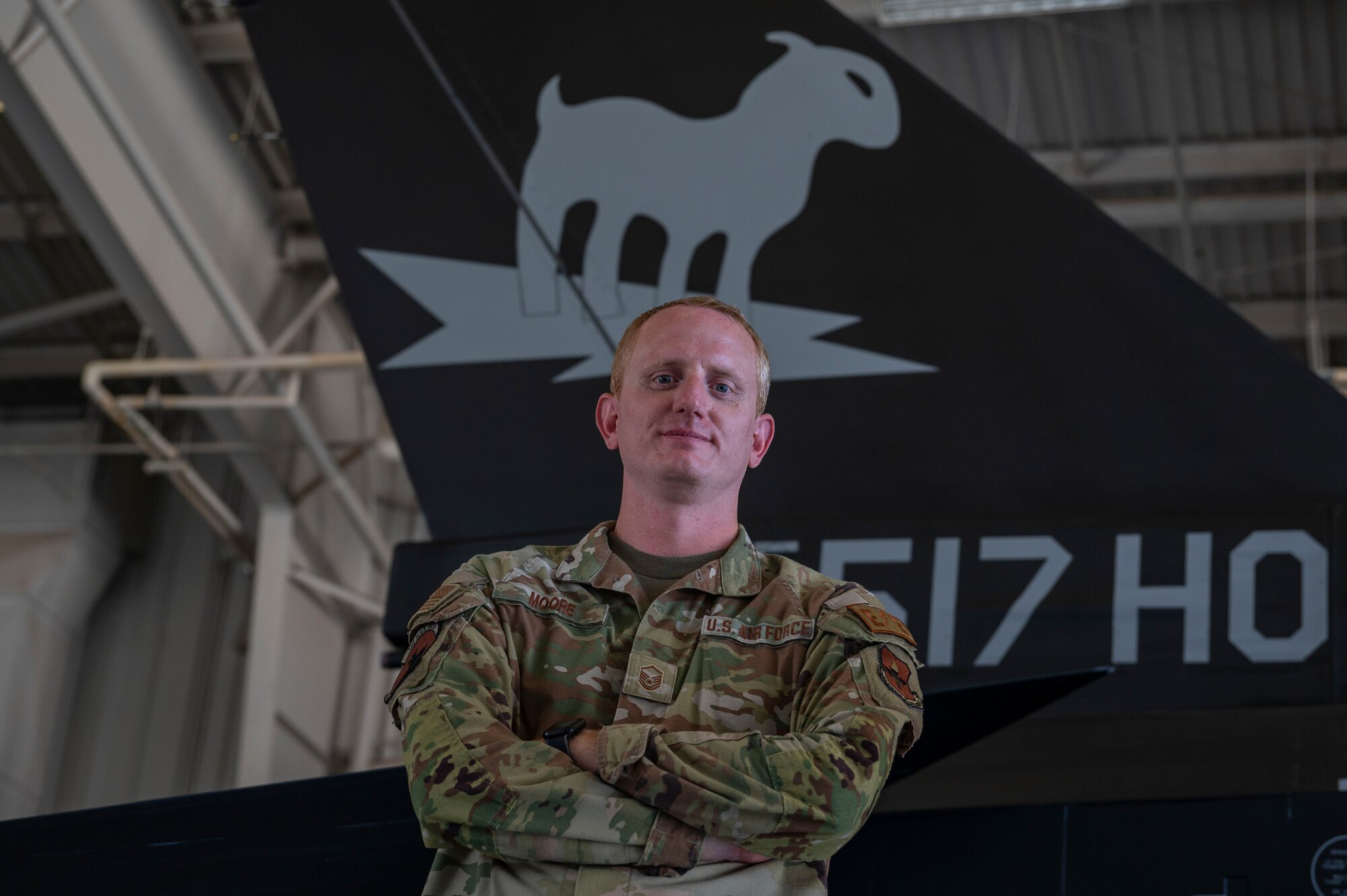 U.S. Air Force Master Sgt. Daniel Moore, 8th Aircraft Maintenance Unit F-16 Viper specialist section chief, poses for a photo with the 8th Fighter Squadron flagship at Holloman Air Force Base, New Mexico, Aug. 13, 2024. In his time in the service, Moore’s path has been shaped by a series of decisions, challenges, and personal growth that have defined his 14-year tenure in the Air Force. (U.S Air Force photo by Senior Airman Isaiah Pedrazzini)
