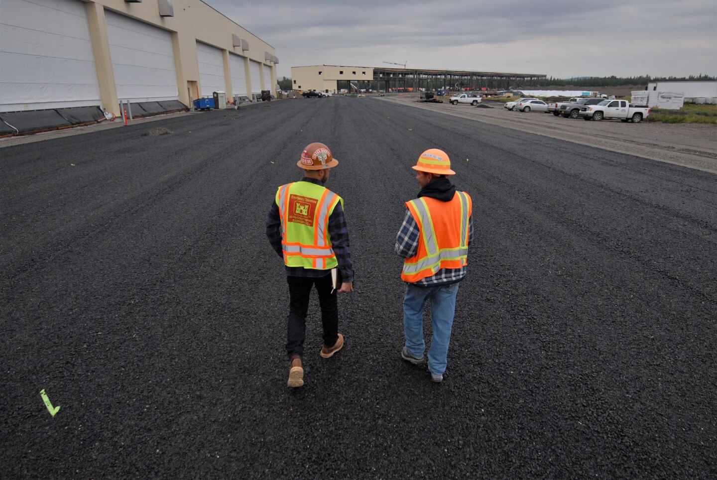 USACE construction personnel walk near a recently completed hangar complex for newly stationed F-35s at Eielson Air Force Base near North Pole, Alaska. The Department of Defense invested about $600 million on a beddown program at the installation located near North Pole, Alaska. Also known as the “joint strike fighter,” two new squadrons of 54 aircraft now have the proper facilities to support their missions thanks to the design and construction work of the U.S. Army Corps of Engineers – Alaska District.