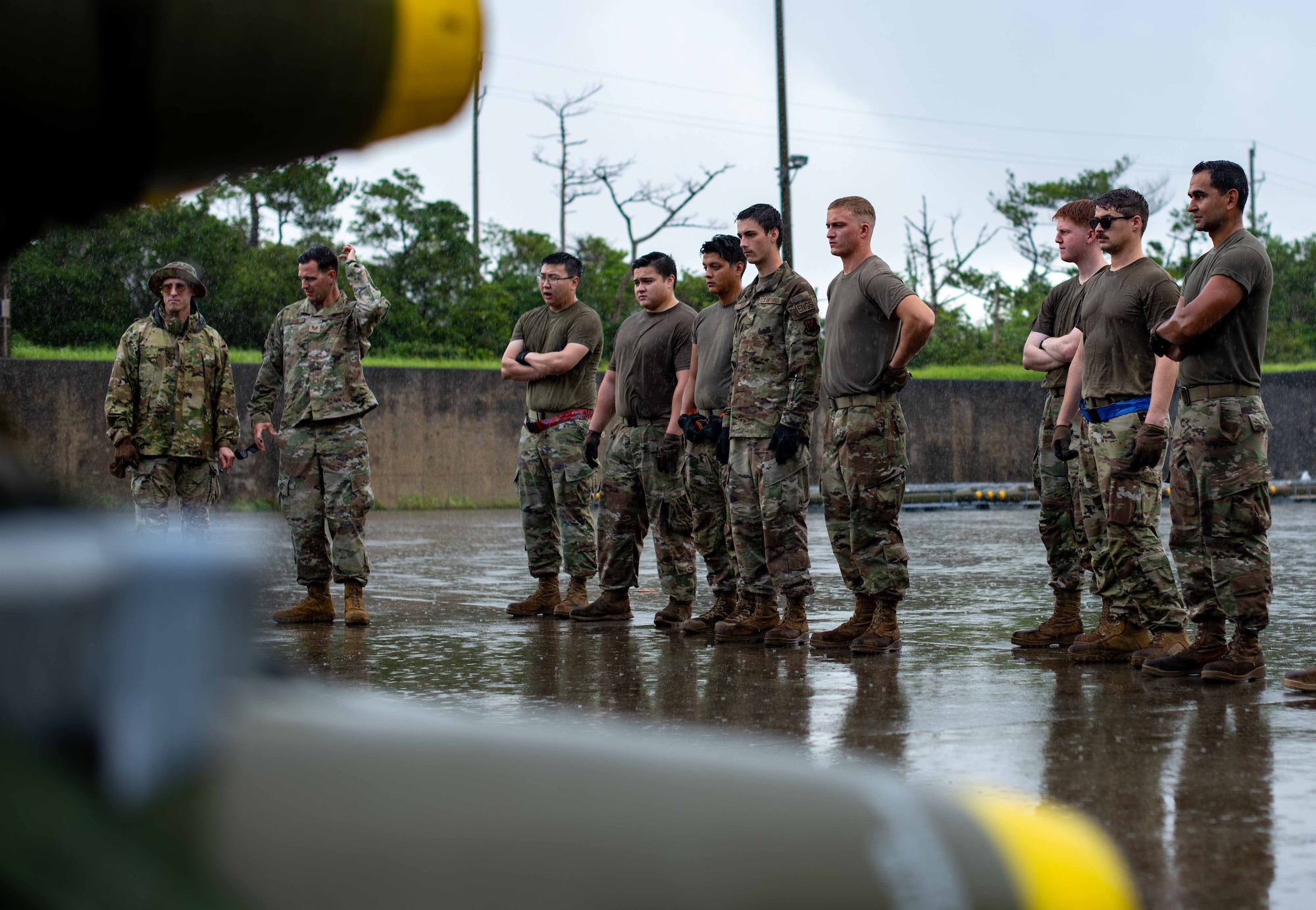 U.S. Air Force Airmen observe a munition loading demonstration during a tactical air-munitions rapid response package training at Kadena Air Base, Japan, Aug. 20, 2024.