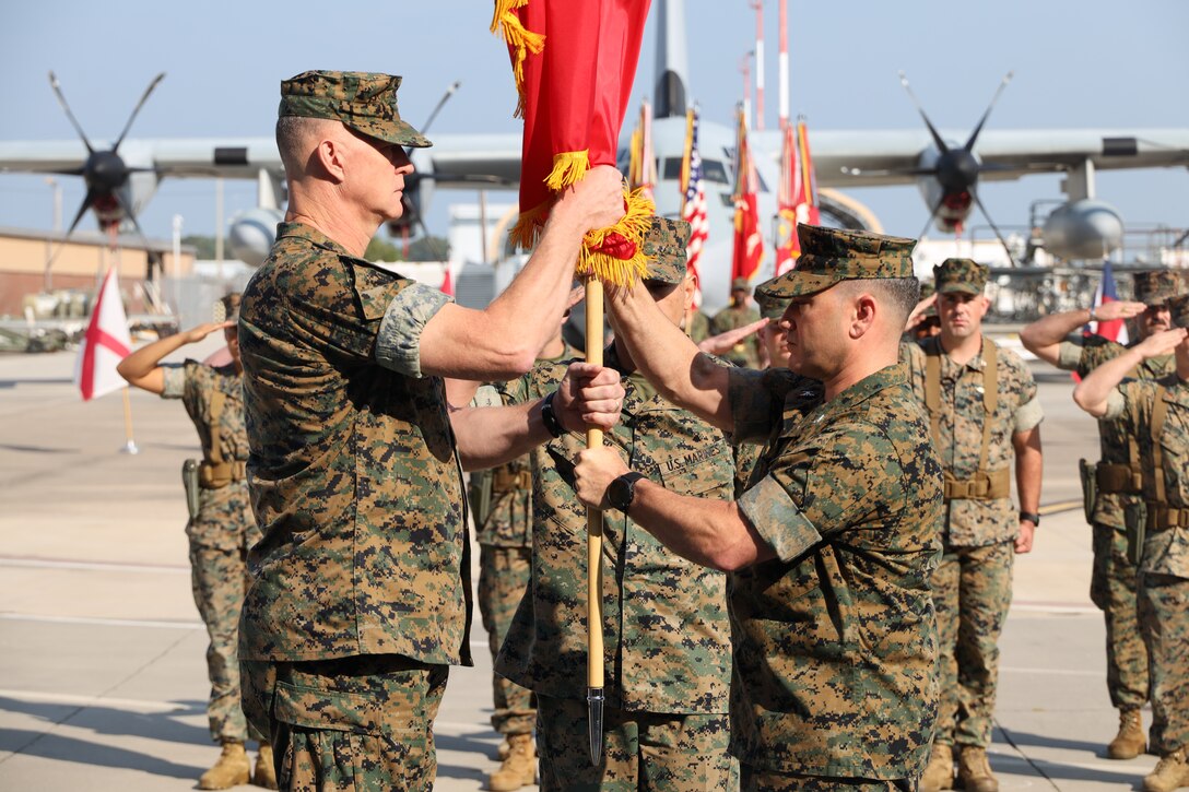 U.S. Marine Corps Col. Benjamin W. Grant, left, from Ohio, the oncoming commanding officer of Marine Aircraft Group (MAG) 14, receives the ceremonial colors from Col. James T. Bardo, from California, the outgoing commanding officer of Marine Aircraft Group (MAG) 14 during a change of command ceremony at Marine Corps Air Station Cherry Point, North Carolina, Aug. 16, 2024. The ceremony represented a transfer of responsibility, authority, and accountability from Bardo to Grant. (U.S. Marine Corps photo by Staff Sgt. Theodore Bergan)