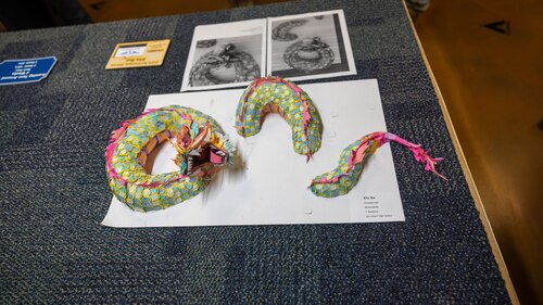 Photo of dragon sculpture on table.