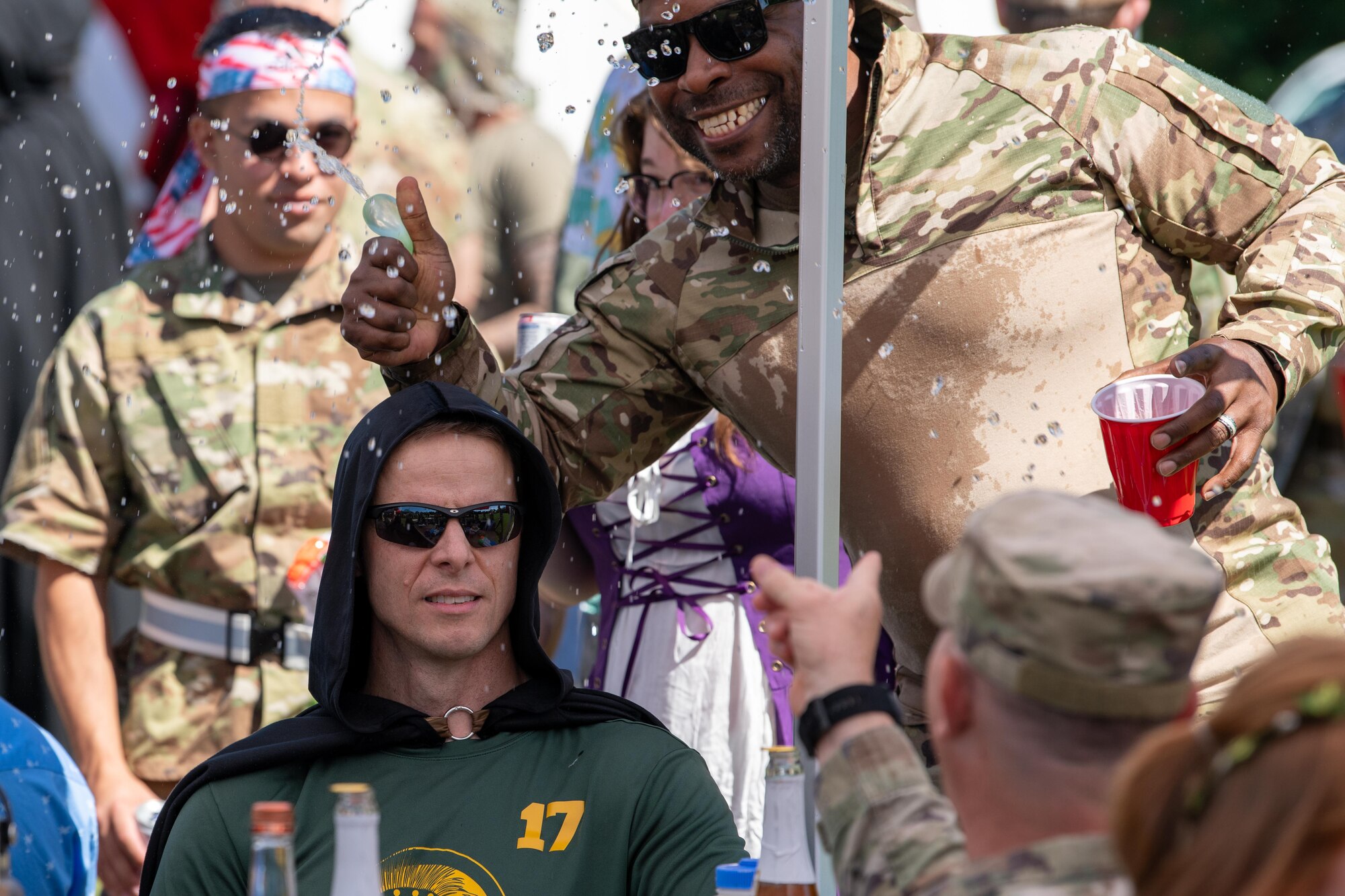 Airman pops water balloon over another's head