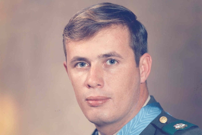 A man in uniform poses for a photo.